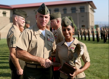U.S. Marine Brig. Gen. David A. Ottignon presents Sgt. Lara Deleon with the I Marine Expeditionary Force Navy and Marine Corps Association Leadership Award at the 1st Marine Logistics Group quarterly awards ceremony aboard Camp Pendleton Calif., July 29, 2016. Ottignon is the 1st MLG commanding general and Deleon is a maintenance chief with Headquarters Regiment. Deleon was one of the Marines recognized at the ceremony for their outstanding achievements in the performance of their duties for the fiscal year 2016 third quarter. (U.S. Marine Corps photo by Sgt. Carson Gramley/released)
