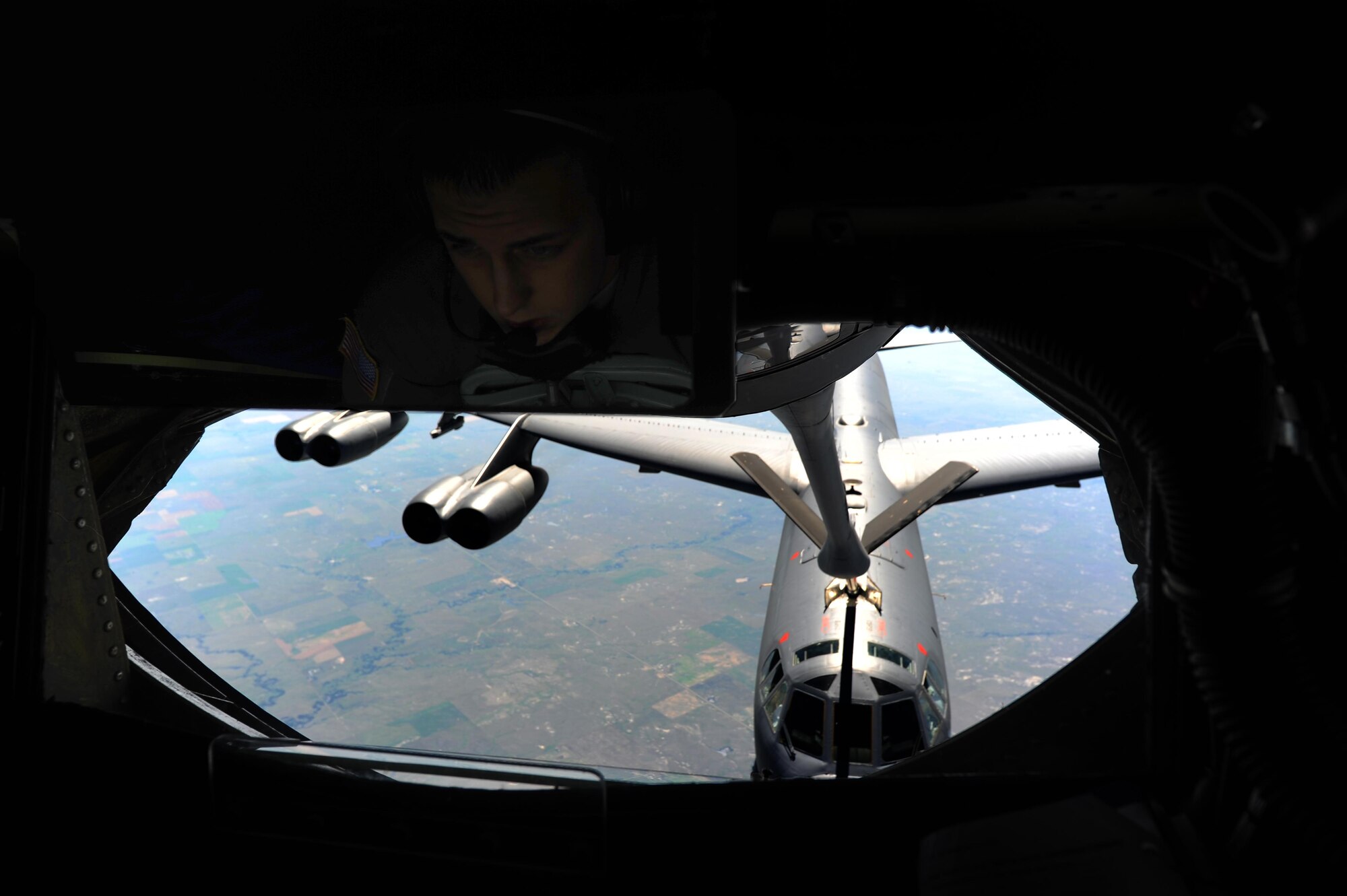 Airman 1st Class Brandon Divins, 349th Air Refueling Squadron KC-135 Stratotanker boom operator, refuels a B-52 Stratofortress above Minnesota, July 31, 2016. Four of McConnell's KC-135s provided a non-stop flight for two B-52s to participate in Polar Roar. Polar Roar is a mission held in the Arctic Circle that demonstrates flexible and vigilant long-range global-strike capability. (U.S. Air Force photo/Airman 1st Class Christopher Thornbury)