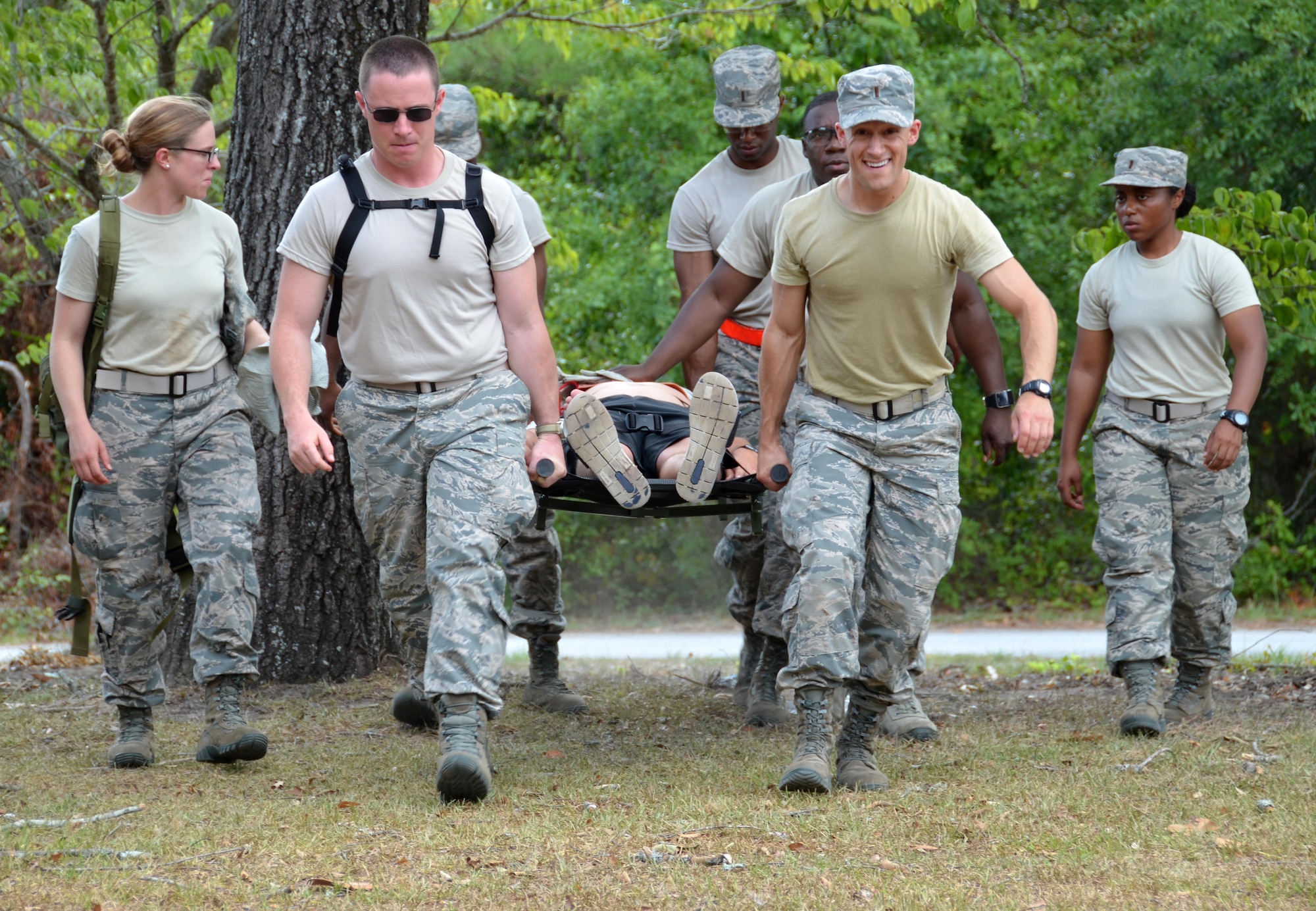 Chaplain candidates 2nd Lt. Kara Dula, 2nd Lt. Seth Duhs, 2nd Lt. Tyler Brown, 2nd Lt. Caleb Walker, and 2nd Lt. Jasmin Luck, work together to hoist and carry a casualty to a safe location at Robins Air Force Base, Georgia, July 25, 2016. The candidates had just completed self-aid buddy care classroom instruction when they were rushed outside to put their new knowledge to the test when an "attack" happened outside, resulting in casualties. The candidates are participants in the Air Force Reserve Command Chaplain Candidate Intensive Interview program which aims to provide an extensive overview of what the Air Force Reserve mission is as well as a broad overview of the military chaplain corps.(U.S. Air Force photo/Tech. Sgt. Kelly Goonan)