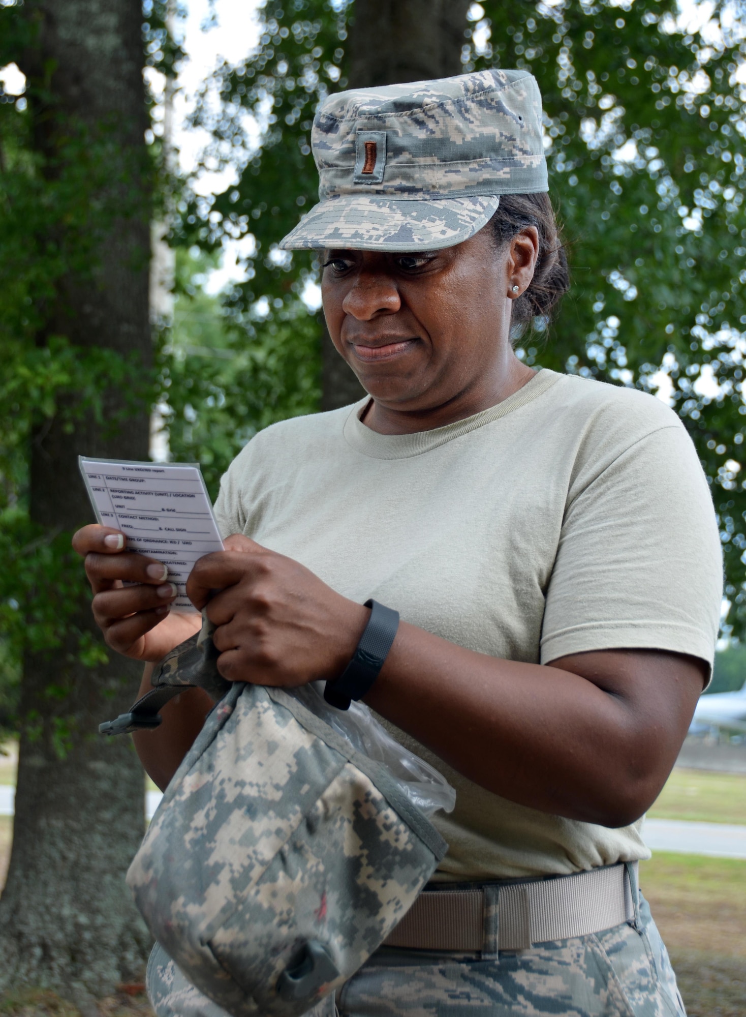 2nd Lieutenant Tiesha Simmons, Chaplain Candidate, reads through the 9 Line information as she calls for a medical evacuation during a training scenario with "wounded" civilians at Robins Air Force Base, Georgia, July 25, 2016. The candidates had just completed self-aid buddy care classroom instruction when they were rushed outside to put their new knowledge to the test when an "attack" happened outside, resulting in casualties. During the last week of the Air Force Reserve Command Chaplain Candidate Intensive Interview program, twenty-five candidates were immersed in fast-paced mobility training conducted by active-duty instructors from the 5th CBCSS. This mobility training, typically a two-week process, was condensed and compacted to fit into the two-day window the candidates had available. They received instruction on self-aid and buddy care, land navigation, and participated in mock scenarios that were aimed to prepare them for what they could possibly see in a deployed environment.