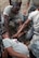 2nd Lieutenant Willy Gedeon, Chaplain Candidate, provides self-aid buddy care by holding pressure on an open wound during a training scenario with 