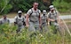 A group of chaplain candidates enter a wooded area as they use their land navigation training to find their specified location at Robins Air Force Base, Georgia, July 25, 2016. The candidates are participating in the Air Force Reserve Command Chaplain Candidate Intensive Interview program which aims to provide an extensive overview of what the Air Force Reserve mission is as well as a broad overview of the military chaplain corps. During the last week of the program, the candidates were immersed in fast-paced mobility training conducted by active-duty instructors from the 5th Combat Communications Squadron Support. (U.S. Air Force photo/Tech. Sgt. Kelly Goonan)