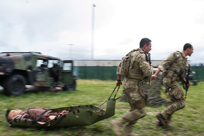 U.S. Air Force Staff Sgt. Kristopher Harpoon and Airman 1st Class Aaron Osbourne, 5th Air Support Operations Squadron, Joint Base Lewis-McChord, Wash., tactical air control party specialists, rescue a simulated victim from a damaged vehicle during the causality evacuation exercise as part of Cascade Challenge July 19, 2016, at Fort Wainright, Alaska. The competitors had to transport the casualty to safety while in a simulated firefight with enemy combatants. 
