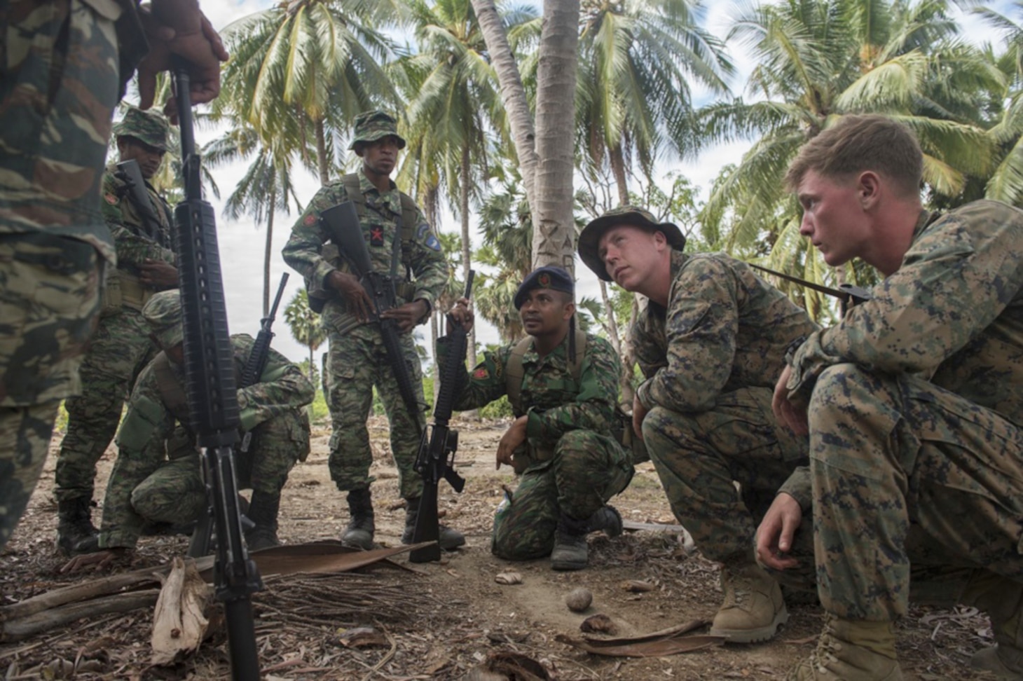 U.S. Marine Sgt. Christopher Krieg, assigned to Fleet Anti-terrorism Security Team Pacific, listens to a question from a Forsa Defesa Timor-Leste (F-FDTL) service member while discussing convoy ambushes during Cooperation Afloat Readiness and Training (CARAT) Timor-Leste 2016. The focus of CARAT is developing maritime security capabilities and increasing interoperability among participants. Skill areas exercised during CARAT include Maritime Interdiction Operations; riverine, amphibious and undersea warfare operations; diving and salvage operations; naval gunnery and maneuvering events, along with disaster response exercises.