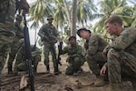 U.S. Marine Sgt. Christopher Krieg, assigned to Fleet Anti-terrorism Security Team Pacific, listens to a question from a Forsa Defesa Timor-Leste (F-FDTL) service member while discussing convoy ambushes during Cooperation Afloat Readiness and Training (CARAT) Timor-Leste 2016. The focus of CARAT is developing maritime security capabilities and increasing interoperability among participants. Skill areas exercised during CARAT include Maritime Interdiction Operations; riverine, amphibious and undersea warfare operations; diving and salvage operations; naval gunnery and maneuvering events, along with disaster response exercises.