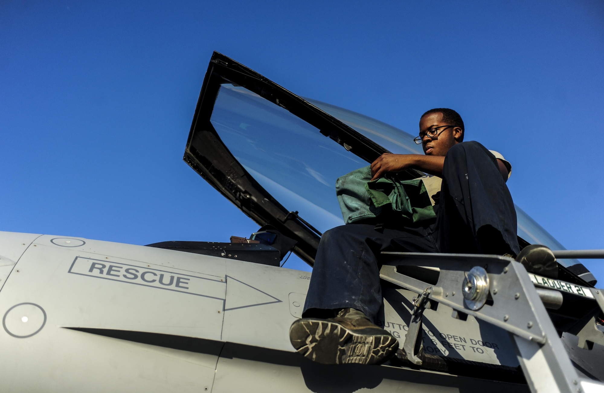 Airman 1st Class Obadiyah Ivens, 555th Fighter Squadron Crew Chief, Aviano Air Force Base, Italy, prepares the cockpit of an F-16 Fighting Falcon at Nellis Air Force Base, Nev., August 2, 2016, for participation in Green Flag 16-8. Green Flag is a close air support and joint exercise administered by the U.S. Air Force Air Warfare Center and Nellis AFB through the 549th Combat Training Squadron. (United States Air Force photo by Airman 1st Class Kevin Tanenbaum/Released)