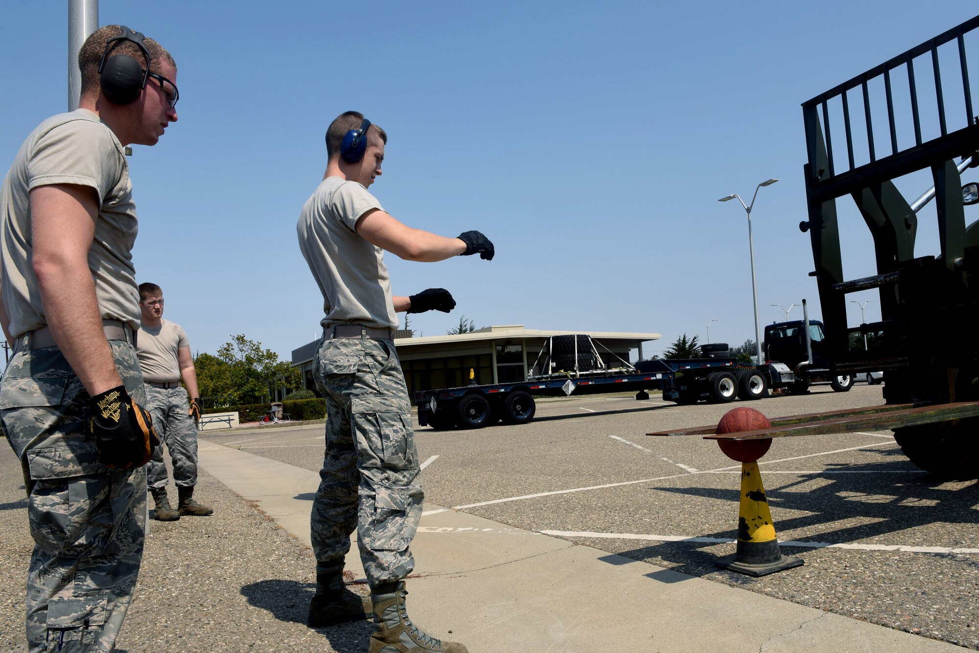 Airmen 1st Class Matthew Peterson, 30th Logistics Readiness Squadron vehicle management and analysis, and James Parish, 30th LRS vehicle maintenance, spot a forklift during the LRS rodeo, July 29, 2016, Vandenberg Air Force Base, Calif. Essentially a timed obstacle course, the LRS rodeo pitted three teams of four Airmen against each other to accomplish various LRS-related tasks while organizers took note of each team’s overall time. (U.S. Air Force photo by Staff Sgt. Shane Phipps/Released)