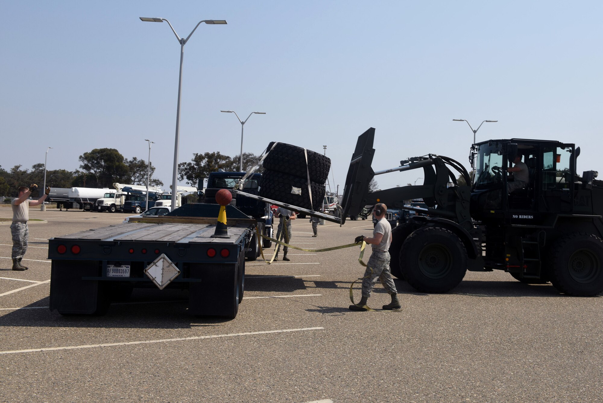 Airmen competing in the 30th Logistics Readiness Squadron rodeo place a pallet on a trailer, July 29, 2016, Vandenberg Air Force Base, Calif. Essentially a timed obstacle course, the LRS rodeo pitted three teams of four Airmen against each other to accomplish various LRS-related tasks while organizers took note of each team’s overall time. (U.S. Air Force photo by Staff Sgt. Shane Phipps/Released)