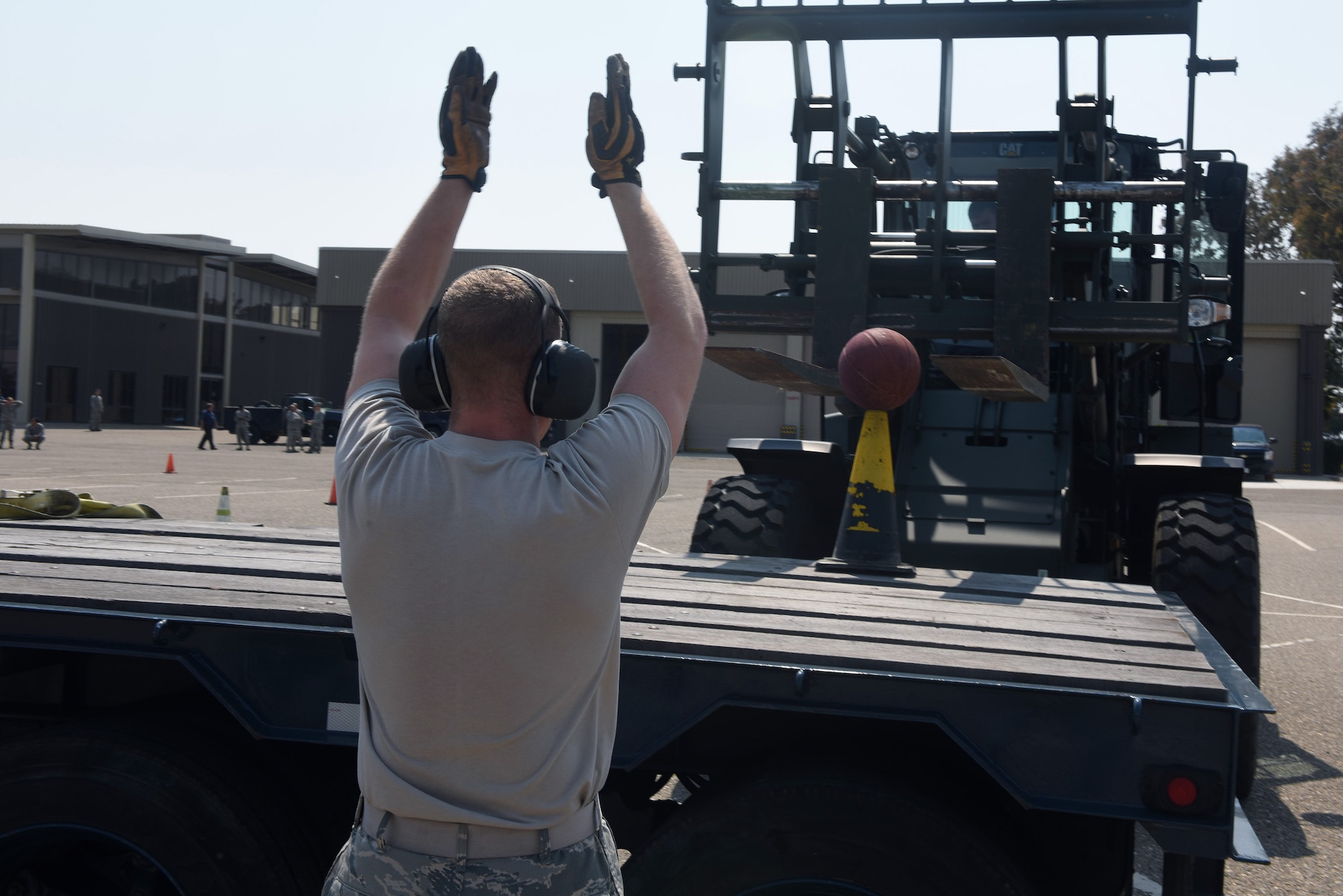 Airman 1st Class James Parish, 30th Logistics Readiness Squadron vehicle maintenance, guides a forklift to its mark during the LRS rodeo, July 29, 2016, Vandenberg Air Force Base, Calif. Essentially a timed obstacle course, the LRS rodeo pitted three teams of four Airmen against each other to accomplish various LRS-related tasks while organizers took note of each team’s overall time. (U.S. Air Force photo by Staff Sgt. Shane Phipps/Released)