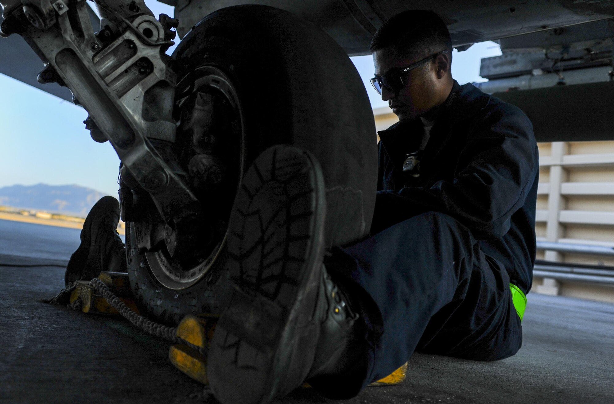 Senior Airman Manuel Jimenez, 555th Fighter Squadron Crew Chief, Aviano Air Force Base, Italy, cleans the landing gear of an F-16 Fighting Falcon at Nellis Air Force Base, Nev., Aug. 2, 2016, before participating in Green Flag 16-8. During exercise execution, Green Flag staff member’s direct, monitor, and instruct visiting units in the conduct of air operations in support of ground forces. (United States Air Force photo by Airman 1st Class Kevin Tanenbaum/Released)