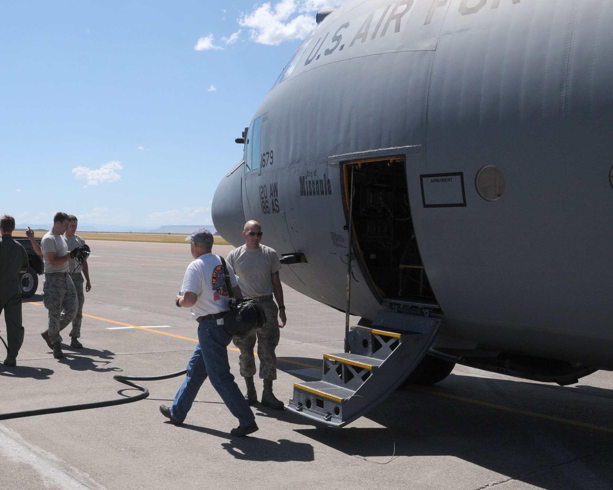 Robert Marquard steps off a C-130 Hercules aircraft July 20 at Great Falls International Airport in Great Falls, Mont. Marquard was the first space-available passenger transported by the 120th Airlift Wing. (U.S. Air National Guard photo / Tech. Sgt. Michael Touchette)