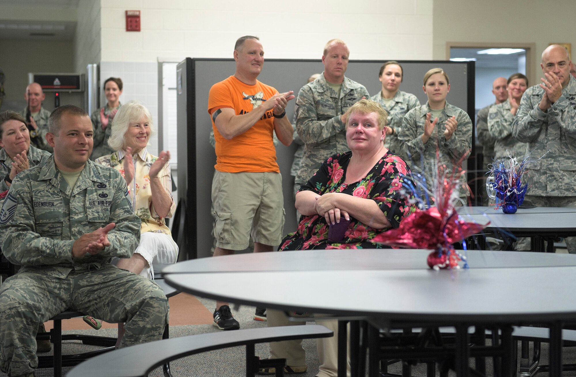 Current and former colleagues applaud Patricia Tetidrick, an administrative support technician with the 182nd Logistics Readiness Squadron, Illinois Air National Guard, at a luncheon held in her honor in Peoria, Ill., July 28, 2016. Tetidrick retired Aug. 1 after 41 years, five months and 21 days of service as a Title 5 federal technician. (U.S. Air National Guard photo by Staff Sgt. Lealan Buehrer)