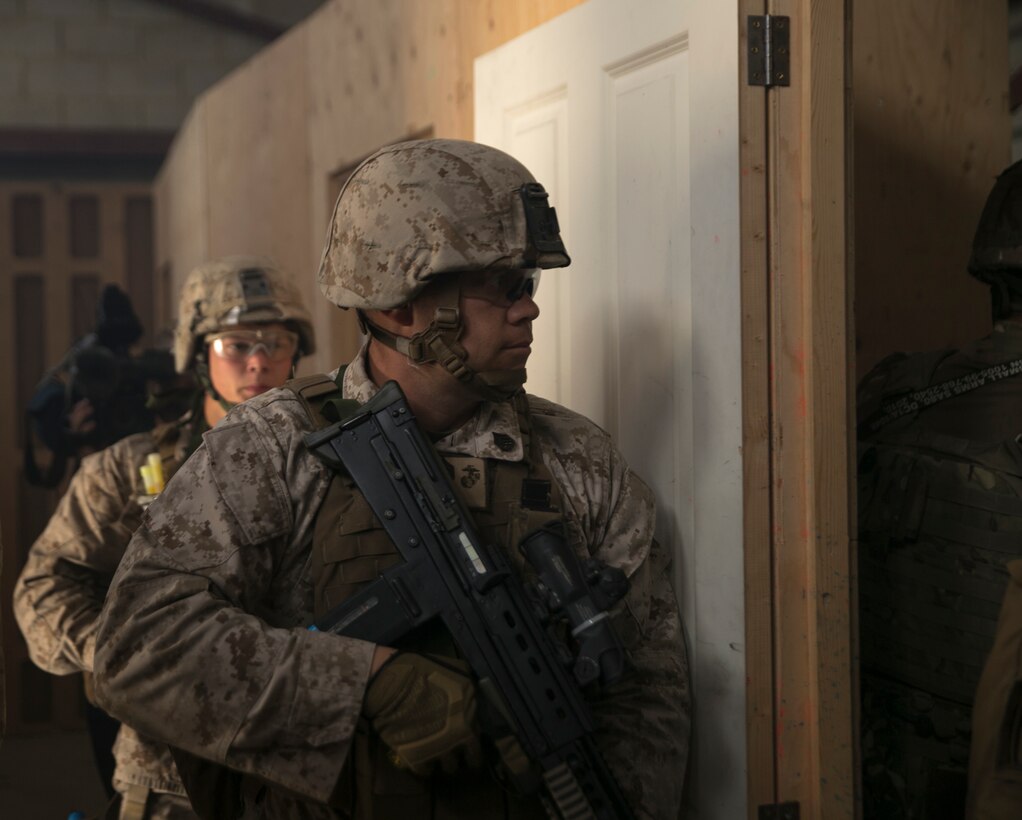 Staff Sgt. Eric McLeish, Marine Corps Security Battalion Bangor, Washington, checks a room before entering during Tartan Eagle 16 at the Northumbria Training Facility in Northumbria, Scotland, July 26, 2016. The CQB portion of Tartan Eagle allowed Marines and sailors to integrate with their British counterparts and exchange tactics while also learning new tactics and procedures.  (Official Marine Corps photo by Sgt. Calvin Shamoon/Released)