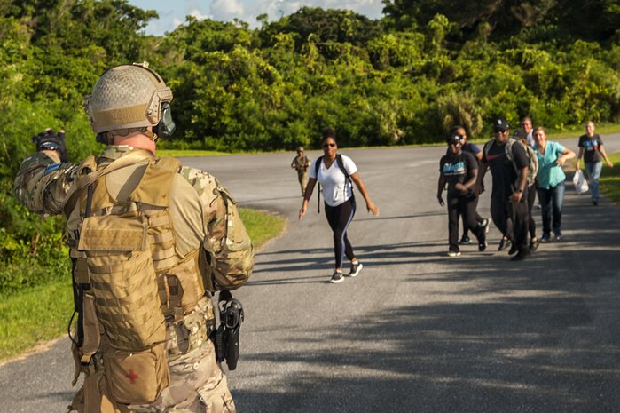 A deployed aircraft ground response element Airman with the 353rd Special Operations Support Squadron stops a group of simulated refugees to search before bringing them on the aircraft during an exercise July 27, 2016, at Kadena Air Base, Japan. The DAGRE team has to be able to handle a wide range of special operations missions, so they routinely practice different scenarios they might encounter. (U.S. Air Force photo by Airman 1st Class Corey M. Pettis)