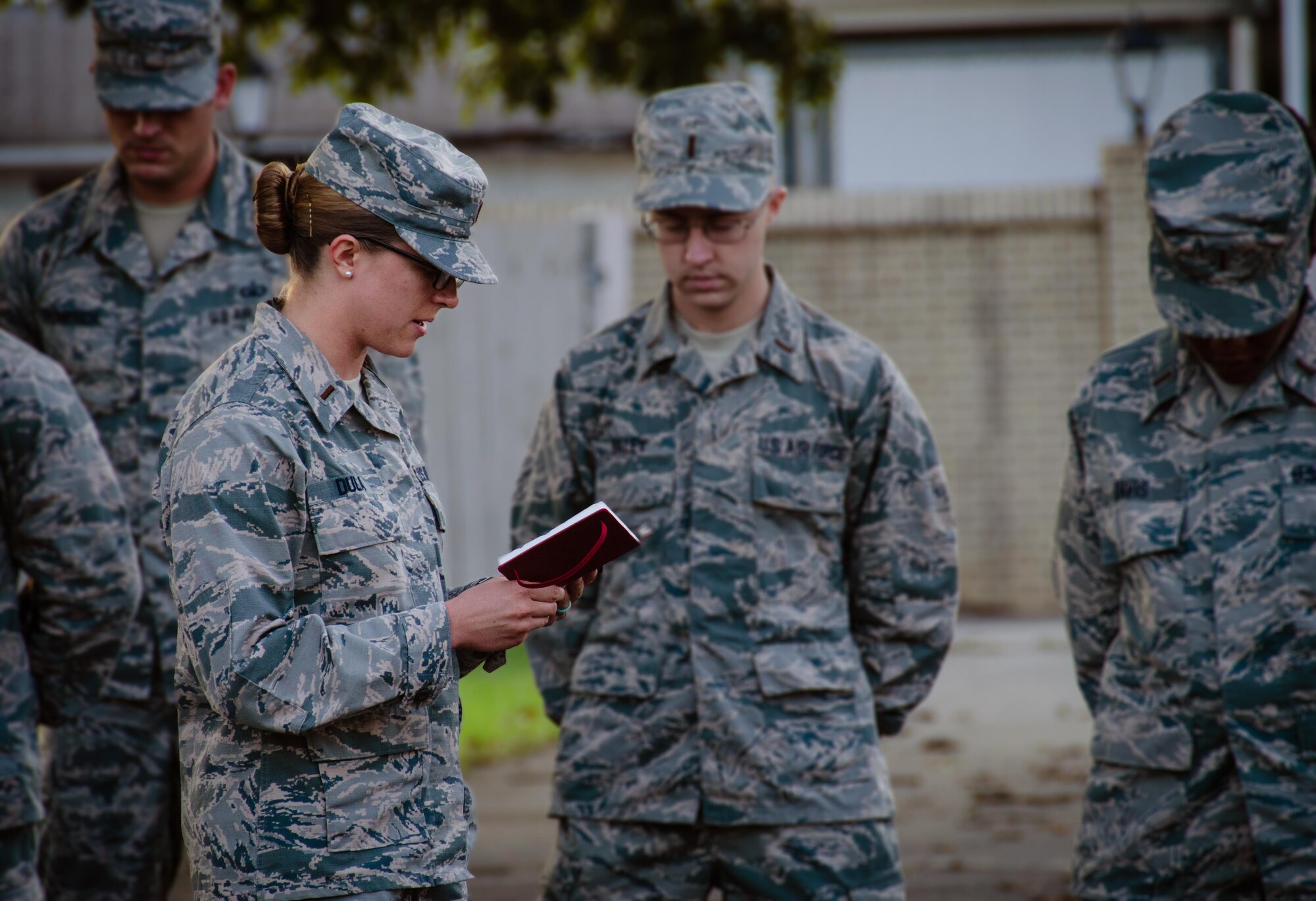 2nd Lt. Chaplain Candidate, Kara Dula reads a morning prayer to the formation of candidates at Robins Air Force Base, Georgia, July 25, 2016. Dula is a participant in the Air Force Reserve Command Chaplain Candidate Intesive Interview program which aims to provide an extensive overview of what the Air Force Reserve mission is as well as a broad overview of the military chaplain corps. During the last week of the AFRC program, the candidates were immersed in fast-paced mobility training conducted by active-duty instructors from the 5th Combat Communications Squadron Support. (U.S. Air Force photo/Tech. Sgt. Kelly Goonan)