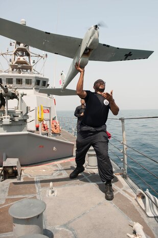 ARABIAN GULF (July 22, 2016)  - Electronics Technician 2nd Class Darius Jackman launches a Puma unmanned aerial vehicle (UAV) from the coastal patrol ship USS Monsoon (PC 4). Monsoon is one of ten coastal patrol ships assigned to Coastal Patrol Squadron (PCRON) 1 home-ported in Manama, Bahrain in support of maritime security operations and theater security cooperation efforts in the U.S. 5th Fleet area of operation. 
