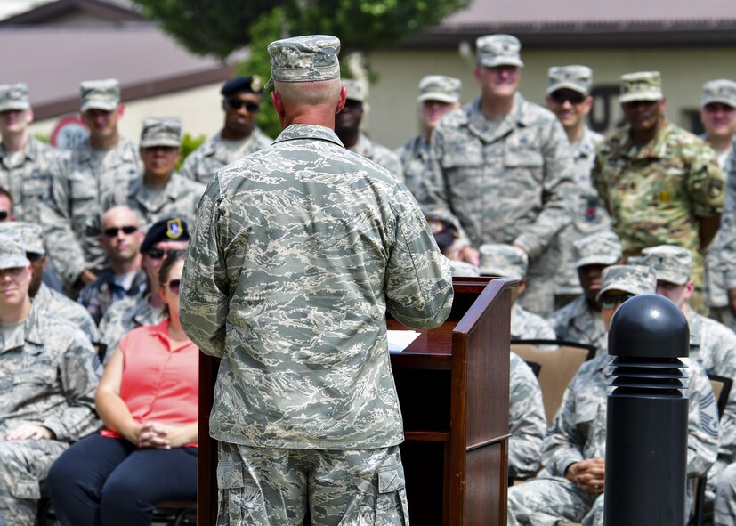 Col. Andrew Hansen, 51st Fighter Wing commander, delivers remarks to the crowd during a re-dedication ceremony at Osan Air Base, Republic of Korea, Aug. 1, 2016. A new statue was erected outside of the base enlisted club in honor of retired Master Sgt. Jim Price, a former Tuskegee Airman who was a part of the Team Osan community for years until his passing in 2008. (U.S. Air Force photo by Senior Airman Victor J. Caputo/Released)