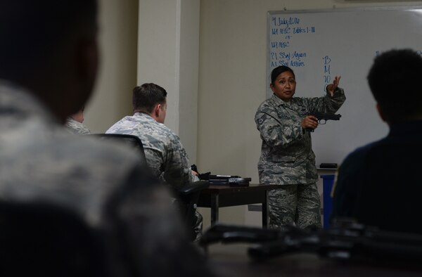 Staff Sgt. Lolita Aguon, 36th Security Forces Squadron combat arms instructor, demonstrates safe and effective use of the M9 pistol July 7, 2016, at Andersen Air Force Base, Guam. Andersen’s combat arms team trains service members and civilians from many Department of Defense organizations on safe and effective use of firearms. (U.S. Air Force photo by Airman 1st Class Jacob Skovo)