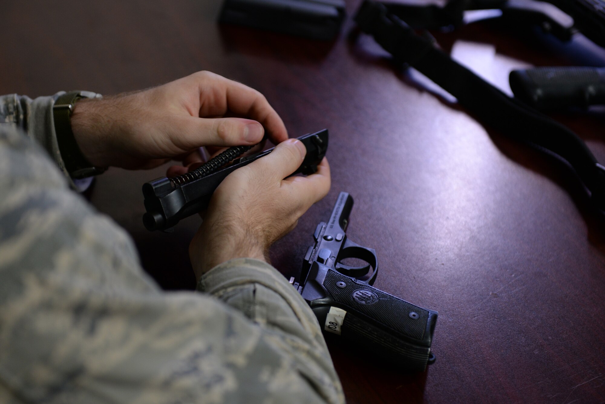 Staff Sgt. Stephen Horton, 36th Security Forces Squadron NCO in charge of resource protection and physical security, assembles an M9 pistol during annual qualification training July 7, 2016, at Andersen Air Force Base, Guam. Prior to firing, students are taught how to handle their weapon, take it apart and conduct preventative maintenance. (U.S. Air Force photo by Airman 1st Class Jacob Skovo)