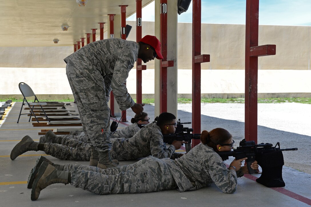 Senior Airman William Brown, 36th Security Forces Squadron combat arms instructor, gives advice to 36th SFS Airmen as they zero-in their weapons July 7, 2016, at Andersen Air Force Base, Guam. Andersen’s combat arms team trains service members and civilians from many Department of Defense organizations.  (U.S. Air Force photo by Airman 1st Class Jacob Skovo)