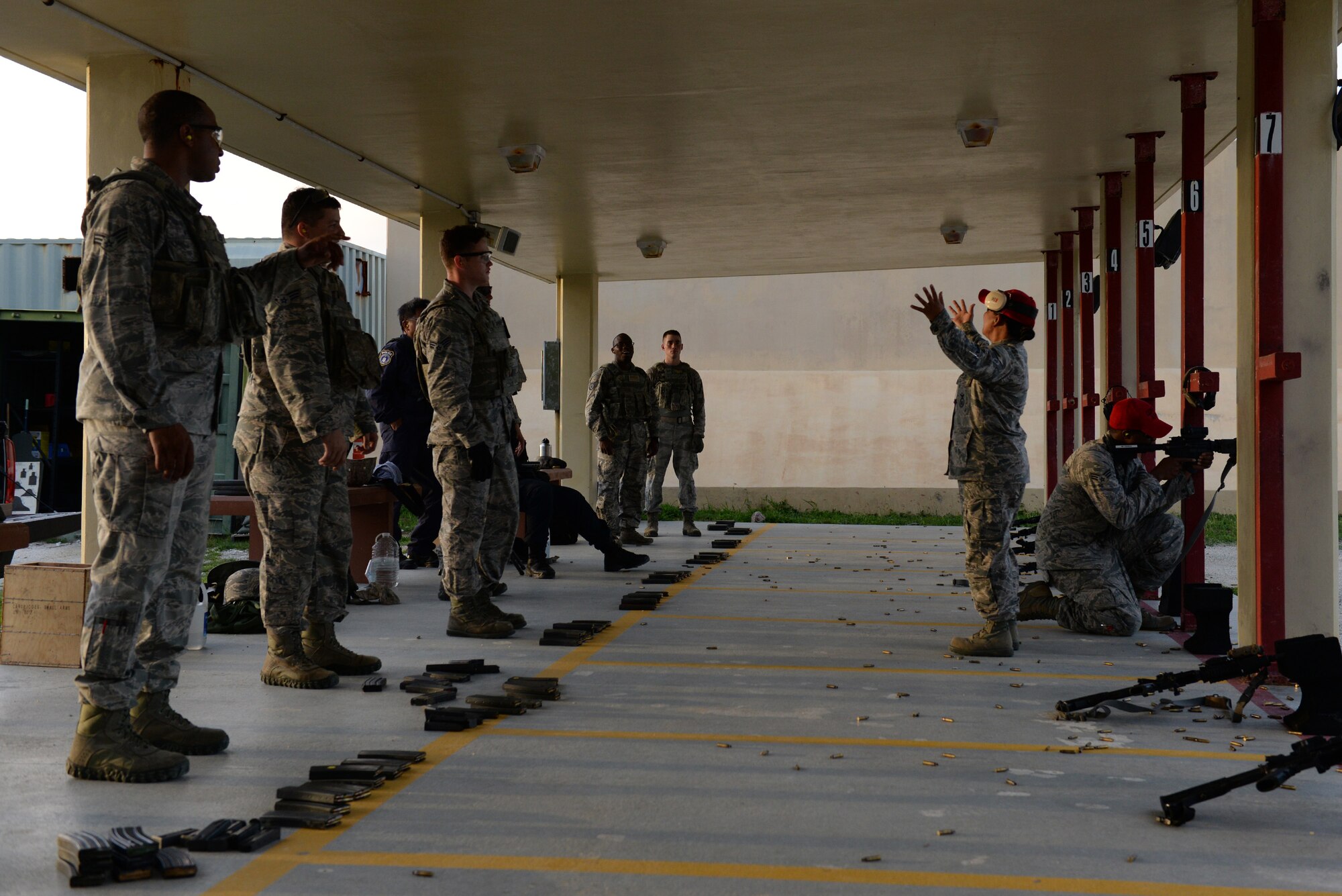 Staff Sgt. Lolita Aguon and Senior Airman William Brown, 36th Security Forces Squadron combat arms instructors, demonstrate firing techniques July 7, 2016, at Andersen Air Force Base, Guam. Weapons qualification is often done in preparation for deployments, for certain permanent changes of station and annually for certain career fields. (U.S. Air Force photo by Airman 1st Class Jacob Skovo)