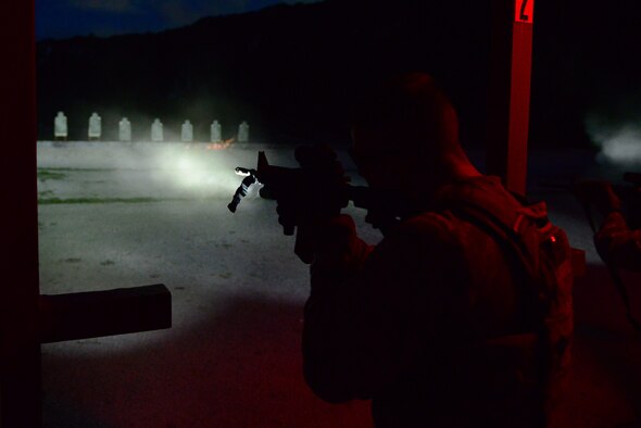 Staff Sgt. Stephen Horton, 36th Security Forces Squadron NCO in charge of resource protection and physical security, fires a M4 carbine while using a mounted flashlight to illuminate his target July 7, 2016, at Andersen Air Force Base, Guam. Training conducted at night consists of using flashlights, night vision sights, lasers and infrared targeting systems. (U.S. Air Force photo by Airman 1st Class Jacob Skovo)