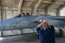 U.S. Air Force Staff Sgt. Michael Hilborn, 44th Aircraft Maintenance Unit crew chief, marshals in a 44th Fighter Squadron F-15 Eagle after returning from an exercise, Aug. 2, 2016, at Kadena Air Base, Japan. The 44th FS participated in Cope Taufan, a training exercise in Malaysia to build strategic partnerships with foreign militaries. (U.S. Air Force photo by Airman 1st Class Corey M. Pettis)