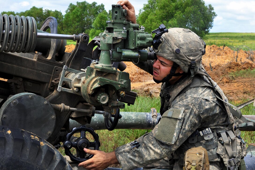 Army Sgt. Erik Paredes finalizes the sighting on an M119 howitzer during training at Fort Polk, La., July 26, 2016. Paredes is assigned to the New York Army National Guard’s 1st Battalion, 258th Field Artillery. Army National Guard photo by Sgt. Maj. Corine Lombardo