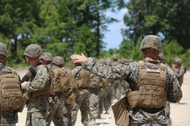 Sgt. Joshua Sizelove, a motor transport mechanic with 2nd Maintenance Battalion, 2nd Marine Logistics Group, instructs Marines at the firing line during a live-fire exercise on Camp Lejeune, N.C., July 29, 2016. The exercise included shooting from the sitting, standing and moving positions, which are all common shooting positions. (U.S. Marine Corps photo by Lance Cpl. Jon Sosner)