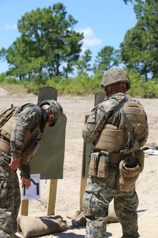 Sgt. Douglas Lancie, a maintenance technician with 2nd Maintenance Battalion, 2nd Marine Logistics group, evaluates the performance of one of his Marines during a live-fire exercise at Camp Lejeune, N.C., July 29, 2016. The Marines shot table three, which consisted of shooting from the sitting, standing, and moving positions. (U.S. Marine Corps photo by Lance Cpl. Jon Sosner)