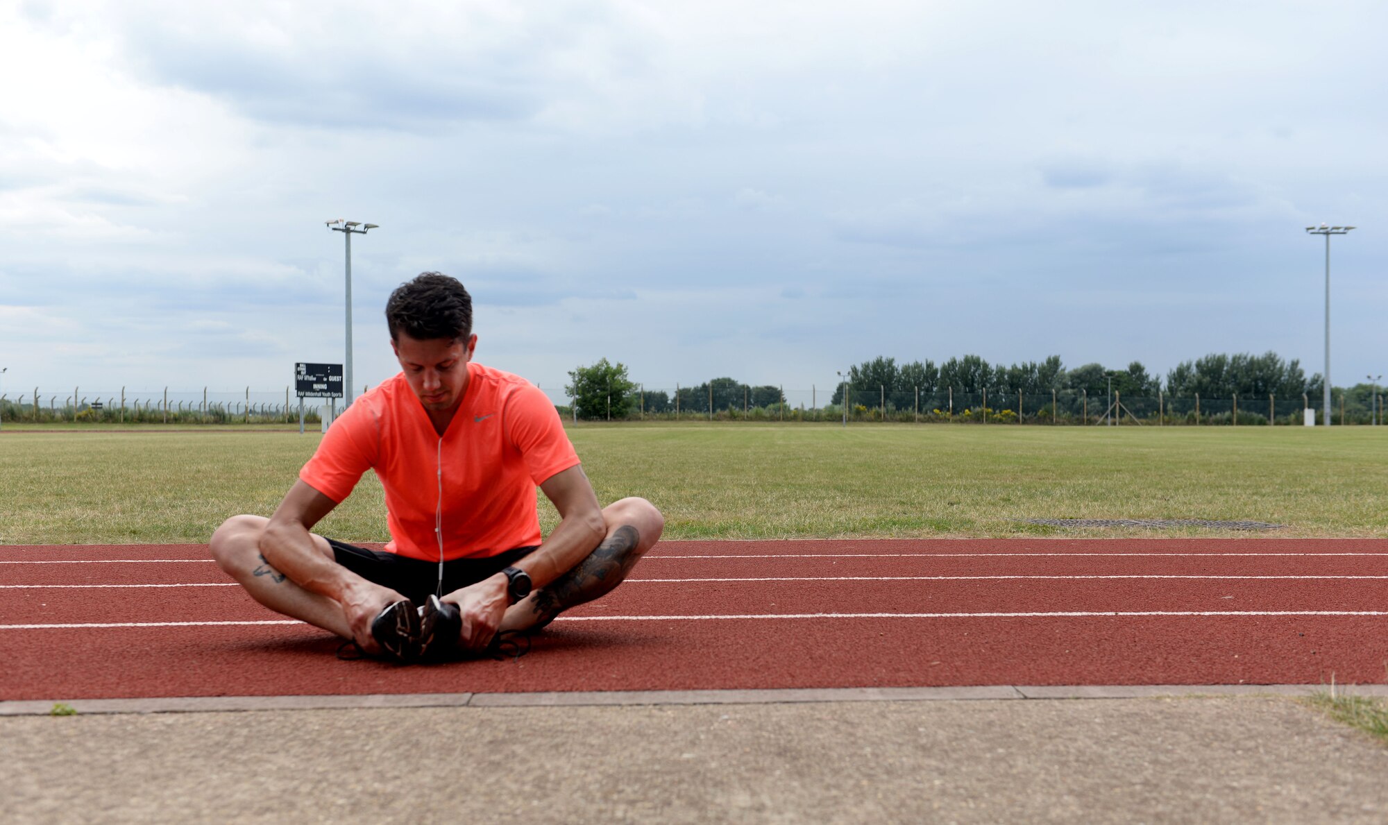 U.S. Air Force Staff Sgt. Benjamin Glenn, 352nd Special Operations Maintenance Squadron CV-22 Osprey dedicated crew chief, finishes a run July 28, 2016, on RAF Mildenhall, England. Glenn was chosen as one of six people to run the half marathon for Air Force Special Operations Command, in hopes of earning big points in the Major Command Challenge. (U.S. Air Force photo by Staff Sgt. Kate Thornton)