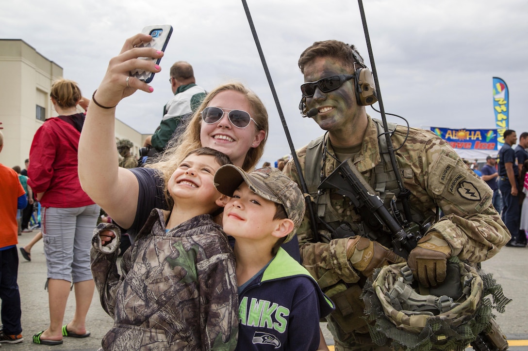 Visitors take a selfie with an Army paratrooper during the Arctic Thunder Open House at Joint Base Elmendorf-Richardson, Alaska, July 31, 2016. The paratrooper is assigned to the 25th Infantry Division’s 4th Brigade Combat Team (Airborne). Air Force photo by Alejandro Pena