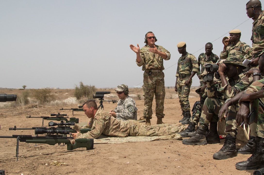 U.S. Army Master Sgt. Mac Broich, an instructor with the Vermont National Guard, instructs Senegalese soldiers at an advanced marksmanship range in Thies, Senegal, as part of Africa Readiness Training 16, July 17, 2016. The exercise is designed to increase U.S. and Senegalese readiness and partnership. U.S. Army photo by Spc. Craig Philbrick
