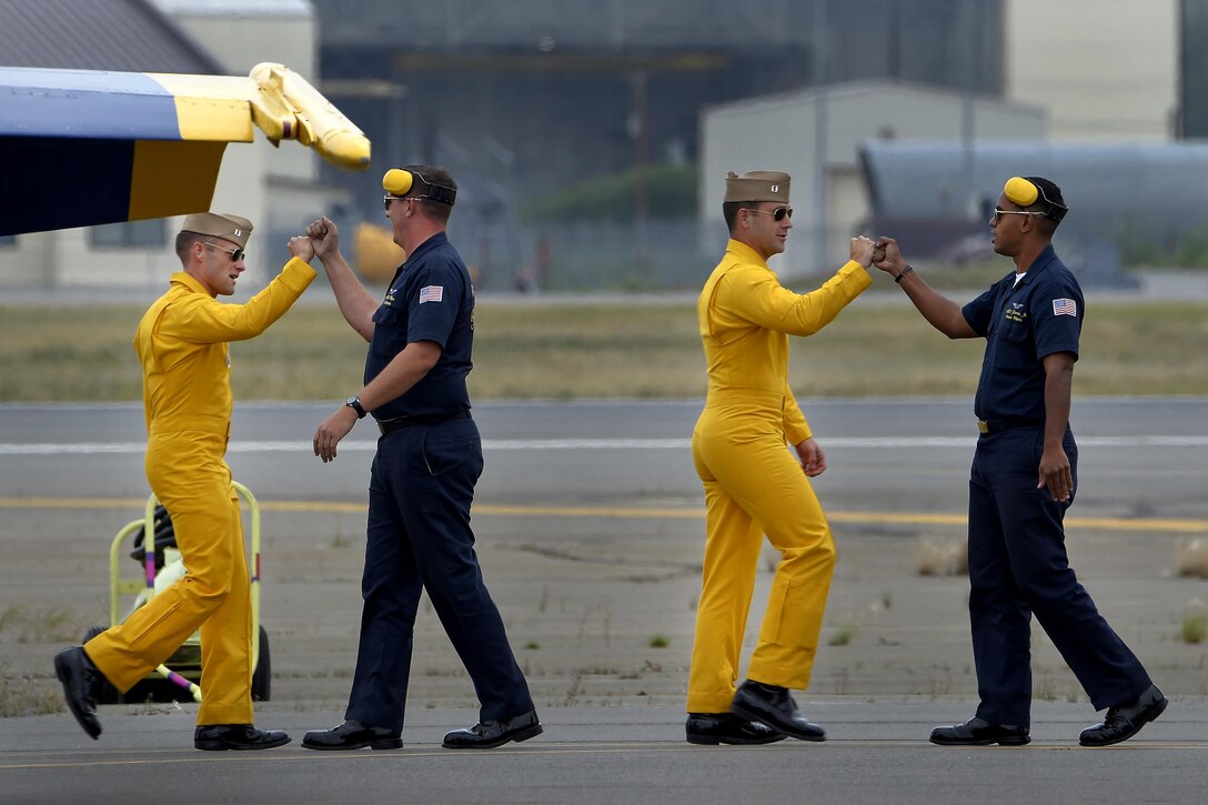 Members of the Blue Angels, the Navy's flight demonstration team, bump fists before a performance at the Arctic Thunder Open House at Joint Base Elmendorf-Richardson, Alaska, July 31, 2016. Air Force photo by Alejandro Pena 