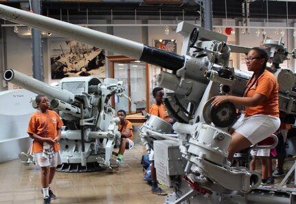 WASHINGTON - Middle and high school students from Camp Dogwood Summer Academy get a Navy gunner’s perspective on 40mm anti-air guns at the National Museum of the United States Navy, July 12. Retired Navy officers joined scientists and engineers from Naval Surface Warfare Center Dahlgren Division and a museum official to brief 29 students from the academy on submarines and exhibits ranging from a diving capsule and torpedo room to a periscope and artic undersea operations, including ice breakthroughs.  