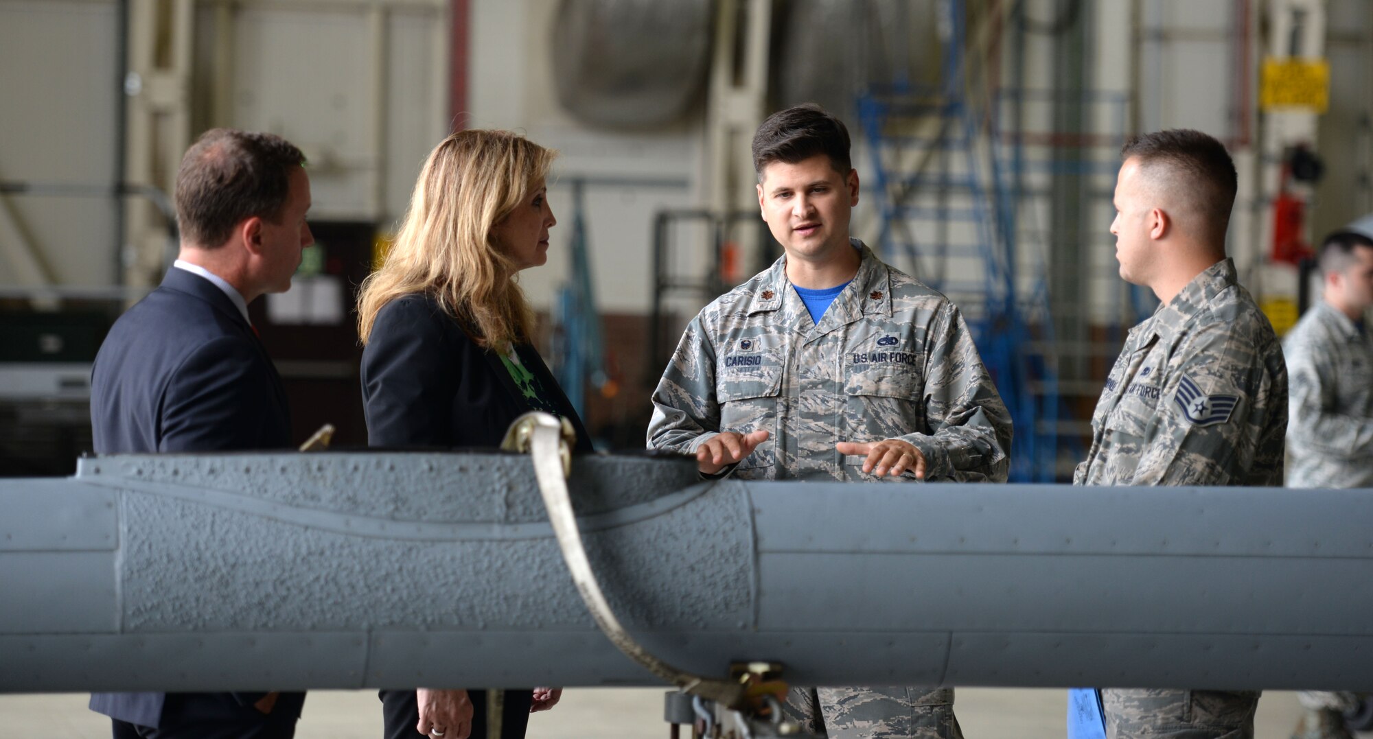 U.S. Air Force Maj. Gerard Carisio, second from right, 100th Maintenance Squadron commander, and U.S. Air Force Staff Sgt. Robert Summerville, right, 100th MXS Aircraft Hydraulics Systems journeyman, explain how the boom of KC-135 Stratotanker works to Amanda Simpson, second from left, Deputy Assistant Secretary of Defense for Operational Energy, and Robert Warshel, left, Director of Operations, Operational Energy Plans and Programs, during a tour of base July 29, 2016, on RAF Mildenhall, England. Simpson received several briefings about the KC-135 isochronal inspection process which highlighted efficiencies gained from continuous process improvement. (U.S. Air Force photo by Gina Randall)