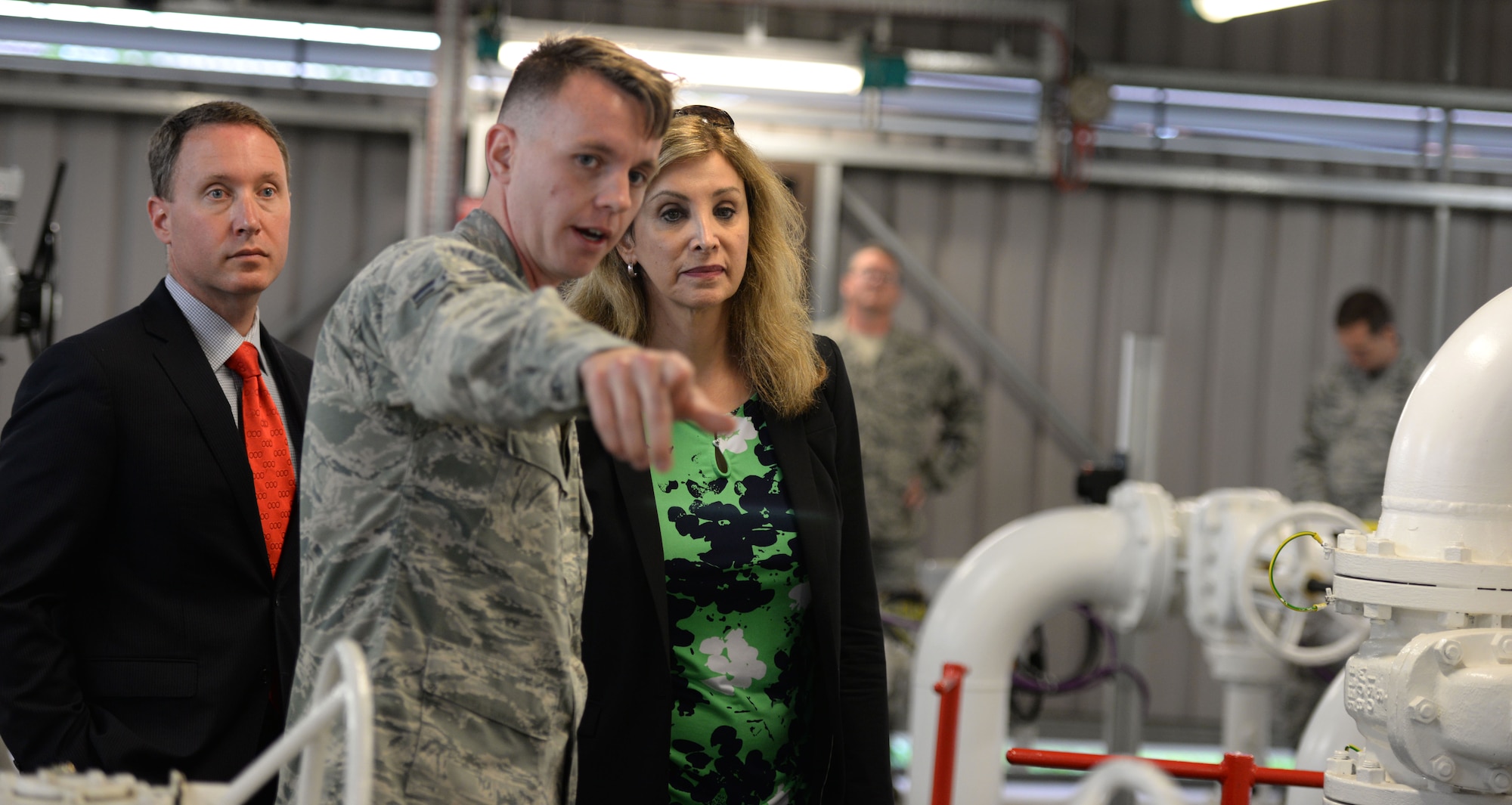 U.S. Air Force Airman 1st Class George Palmer, center, 100th Logistics Readiness Squadron fixed facility operator, shows Amanda Simpson, right, Deputy Assistant Secretary of Defense for Operational Energy, and Robert Warshel, left, Director of Operations, Operational Energy Plans and Programs, the North Tank fuel storage unit July 29, 2016, on RAF Mildenhall, England. During the tour of the base, Simpson and Warshel spoke with Airmen and learned about their mission. (U.S. Air Force photo by Gina Randall)