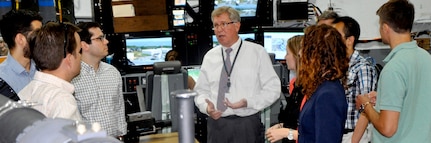 DAHLGREN, Va. - Ralph Stewart, Naval Surface Warfare Center Dahlgren Division (NSWCDD) Battle Management System Program Manager, briefs congressional staffers during the delegation's tour of the NSWCDD Battle Management System and Laboratory, July 29. The staffers - representing congressmen and women from Rhode Island, California, Alabama, Virginia, Hawaii, Indiana and Oklahoma - also received tours and briefings on the electromagnetic railgun, directed energy, virtualization, cybersecurity, and combined integrated air and missile defense-antisubmarine warfare. NSWCDD is a premier research and development center that serves as a specialty site for weapon system integration. The command's unique ability to rapidly introduce new technology into complex warfighting systems is based on its longstanding competencies in science and technology, research and development, and test and evaluation.