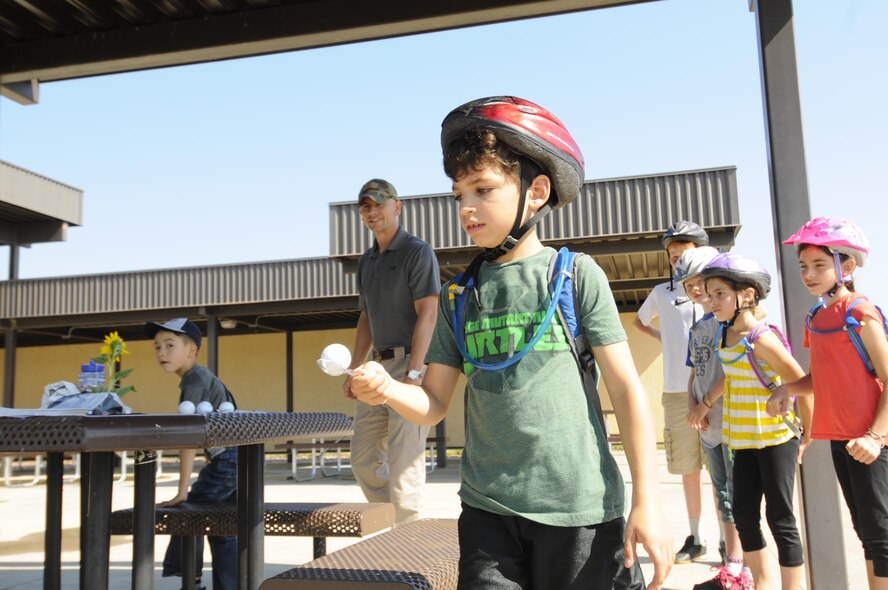 Toby Janaros navigates obstacles while carrying an egg on a spoon during the Amazing gRace: Kids Edition at Schriever Air Force Base, Colorado, Saturday, July 30, 2016. The egg relay was one of eight stations teams had to successfully complete before finishing the scavenger hunt. (U.S. Air Force photo/2nd Lt. Darren Domingo)