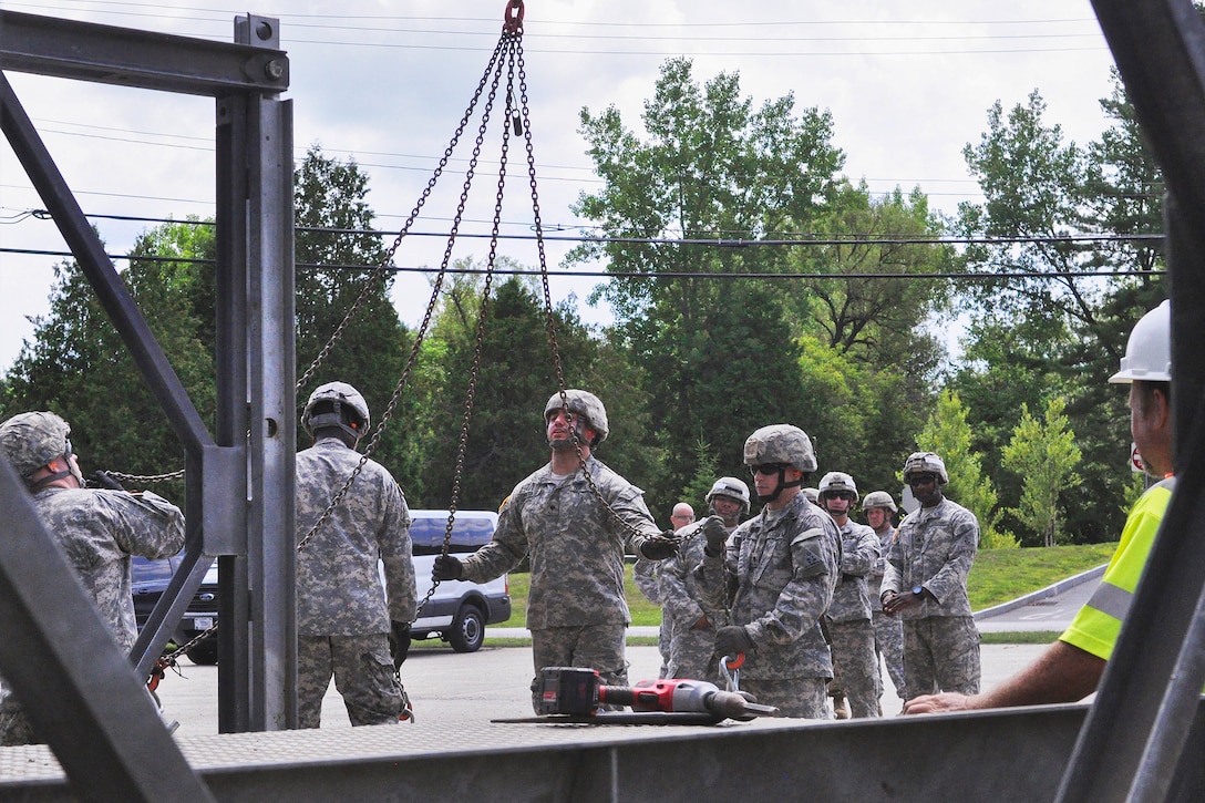 Soldiers learn to assemble a Mabey Logistic Support Bridge from members of the Vermont Agency of Transportation as part of a simulated bridge collapse during the Vigilant Guard 2016 training exercise in Berlin, Vt., July 29, 2016. The soldiers are assigned to the Connecticut National Guard’s 250th Engineer Company. The National Guard and U.S. Northern Command sponsored the exercise, which provides an opportunity for service members to improve cooperation with civilian, military and federal partners as they prepare for emergencies and catastrophic events. Army National Guard photo by Staff Sgt. Ashley Hayes