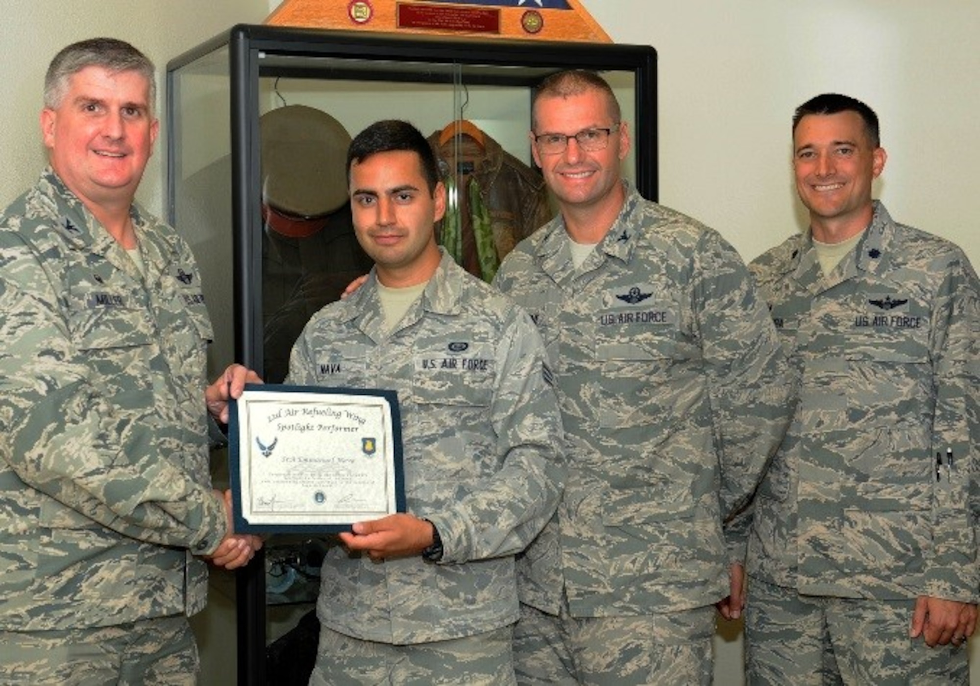 Senior Airman Emmanuel Nava, 22nd Operations Support Squadron intelligence standards and evaluations journeyman, poses with Col. Albert Miller, 22nd Air Refueling Wing commander, Col. Phil Hesseltine, 22nd ARW vice commander, and Lt. Col. Walenga, 22nd OSS commander, July 19, 2016, at McConnell Air Force Base, Kan. Nava received the spotlight performer for the week of June 6-10. (U.S. Air Force photo/Senior Airman David Bernal Del Agua)