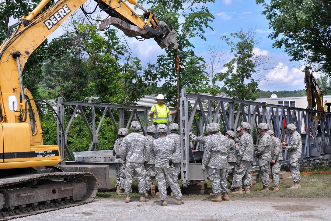 Hobie Gates, center, a special project supervisor for the Vermont Agency of Transportation bridge crew, instructs Connecticut Army National Guardsmen on the assembly of a Mabey Logistic Support Bridge as part of a simulated bridge collapse during the Vigilant Guard 2016 training exercise in Berlin, Vt., July 29, 2016. Army National Guard photo by Staff Sgt. Ashley Hayes