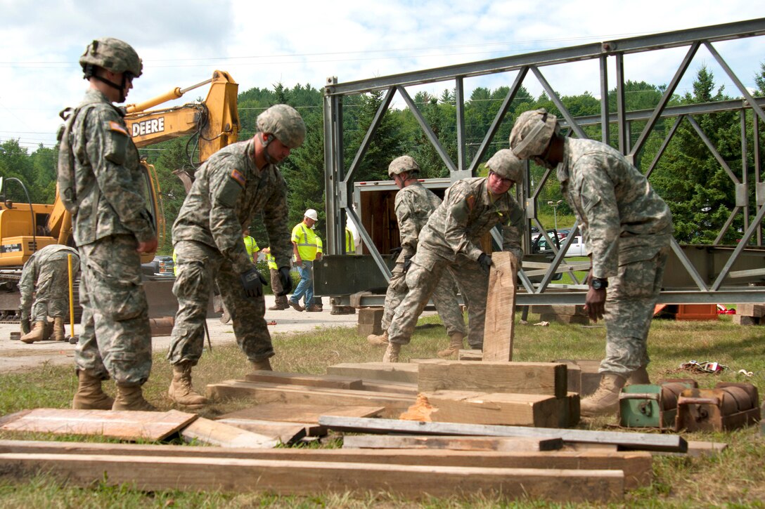 Connecticut Army National Guardsmen  move materials while learing to assemble a Mabey Logistic Support Bridge as part of a simulated bridge collapse during the Vigilant Guard 2016 training exercise in Berlin, Vt., July 29, 2016.  Air National Guard photo by Tech. Sgt. Chelsea Clark 
