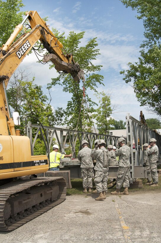 Hobie Gates, left, a special project supervisor for the Vermont Agency of Transportation bridge crew, instructs Connecticut Army National Guardsmen on the assembly of a Mabey Logistic Support Bridge as part of a simulated bridge collapse during the Vigilant Guard 2016 training exercise in Berlin, Vt., July 29, 2016. Air National Guard photo by Tech. Sgt. Chelsea Clark
