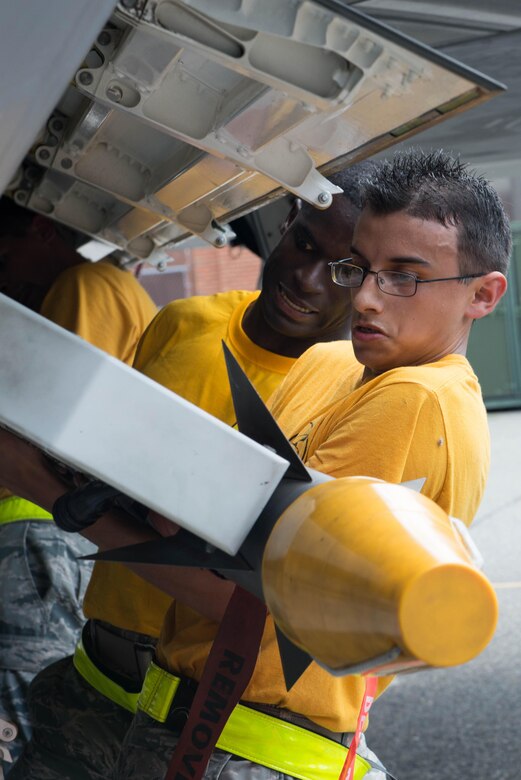 U.S. Air Force Airmen from the 27th Aircraft Maintenance Unit load an AIM-9 missile onto an F-22 Raptor during the 1st Maintenance Squadron Weapons Load Crew of the Quarter competition at Langley Air Force Base, Va., July 29, 2016. 1st Maintenance Group maintainers are responsible for worldwide rapid deployment and employment of combat-ready and mission-capable F-22 Raptors. (U.S. Air Force photo by Staff Sgt. R. Alex Durbin)