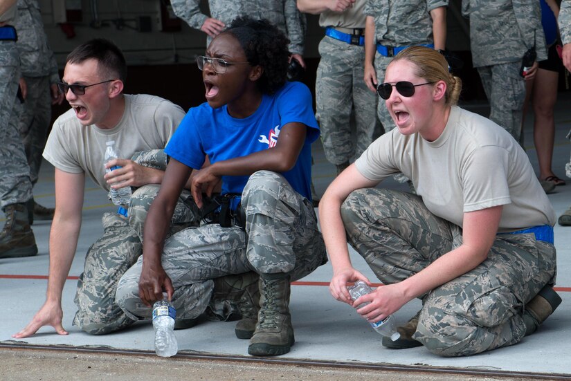 U.S. Air Force Airmen from the 94th Aircraft Maintenance Unit cheer on their fellow Airmen during the 1st Maintenance Squadron Weapons Load Crew of the Quarter competition at Langley Air Force Base, Va., July 29, 2016. This quarter, the 94th AMU team competed as the defending winners. (U.S. Air Force photo by Staff Sgt. R. Alex Durbin)