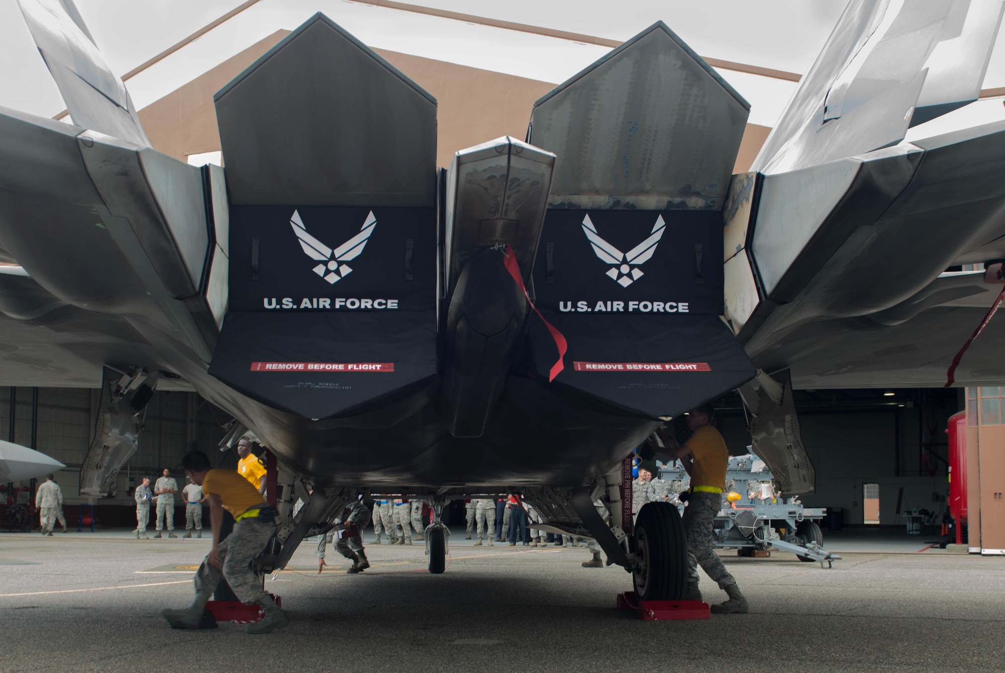 U.S. Air Force Airmen from the 27th Aircraft Maintenance Unit compete during the 1st Maintenance Squadron Weapons Load Crew of the Quarter competition at Langley Air Force Base, Va., July 29, 2016. During the quarterly competition, three-person teams from the 27th and 94th AMUs competed to correctly load two AIM-9 missiles and a GBU-32 Joint Direct Attack Munition the fastest. (U.S. Air Force photo by Staff Sgt. R. Alex Durbin)