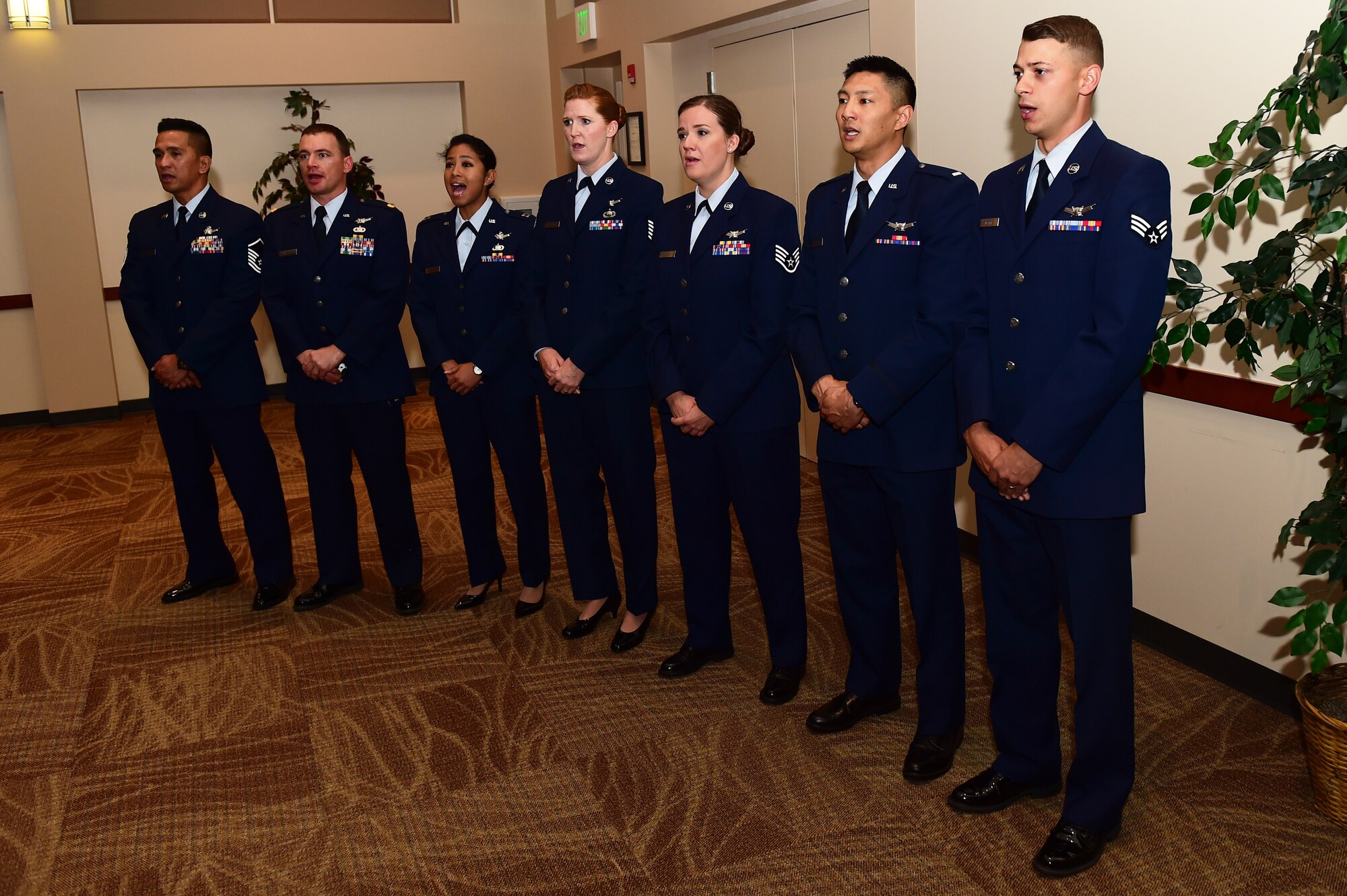 Members of the 2nd Space Warning Squadron and the 8th SWS sing the National Anthem August 2, 2016, during the 460th Operations Group assumption of command ceremony at the Leadership Development Center on Buckley Air Force Base, Colo. The ceremony represents a new commander assuming command of the group and its troops. (U.S. Air Force photo by Airman 1st Class Gabrielle Spradling/Released)
