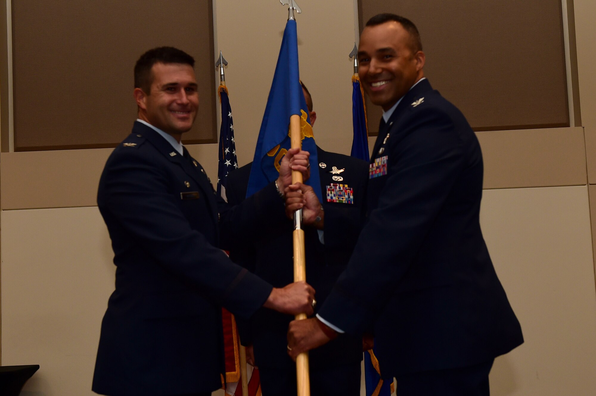 Col. Lorenzo Bradley, 460th Operations Group commander, assumes command August 2, 2016, during the OG assumption of command ceremony at the Leadership Development Center on Buckley Air Force Base, Colo. The guidon is exchanged during the ceremony as a symbol providing a view of the command authority being transferred from one commander to the next. (U.S. Air Force photo by Airman 1st Class Gabrielle Spradling/Released)