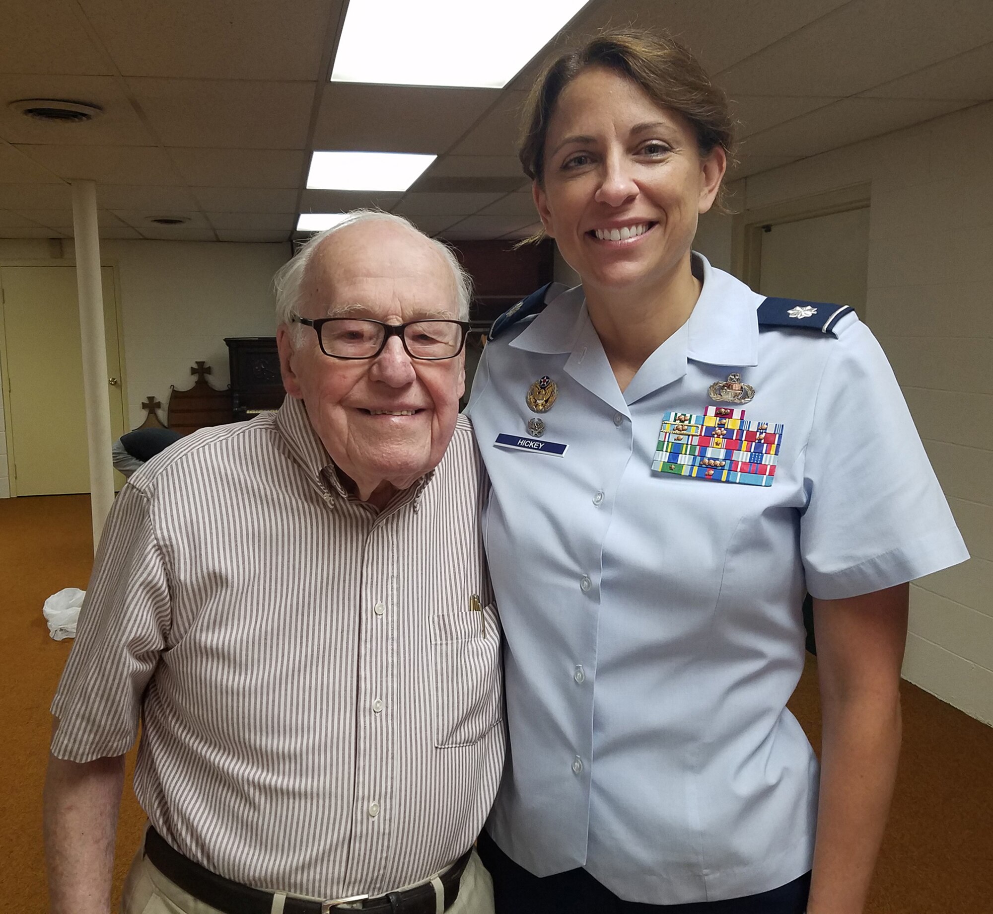WRIGHT-PATTERSON AIR FORCE BASE, Ohio – Lt. Col. Dianne Hickey, 14th Intelligence Squadron commander, met World War II veteran John Johnson June 15, 2016 after learning about his connection to the 14th IS. Johnson was discovered after two years of historical research by the 14th IS as the unit tried to uncover its lineage. Johnson served in the 9th Photographic Technical Squadron during the time of the atomic strikes on Hiroshima and Nagasaki.  (Courtesy photo)